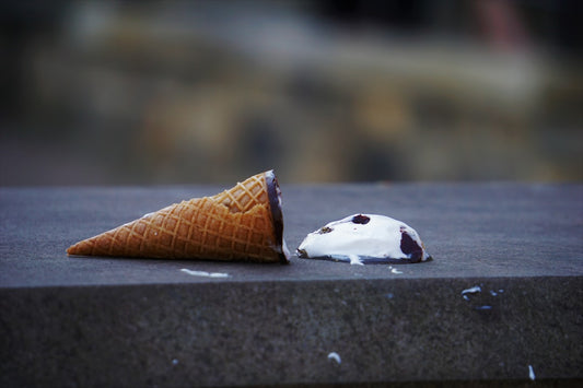 ice cream cone that's been dropped on the ground